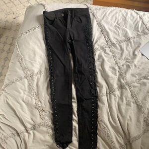Black jeans, with cross on side.